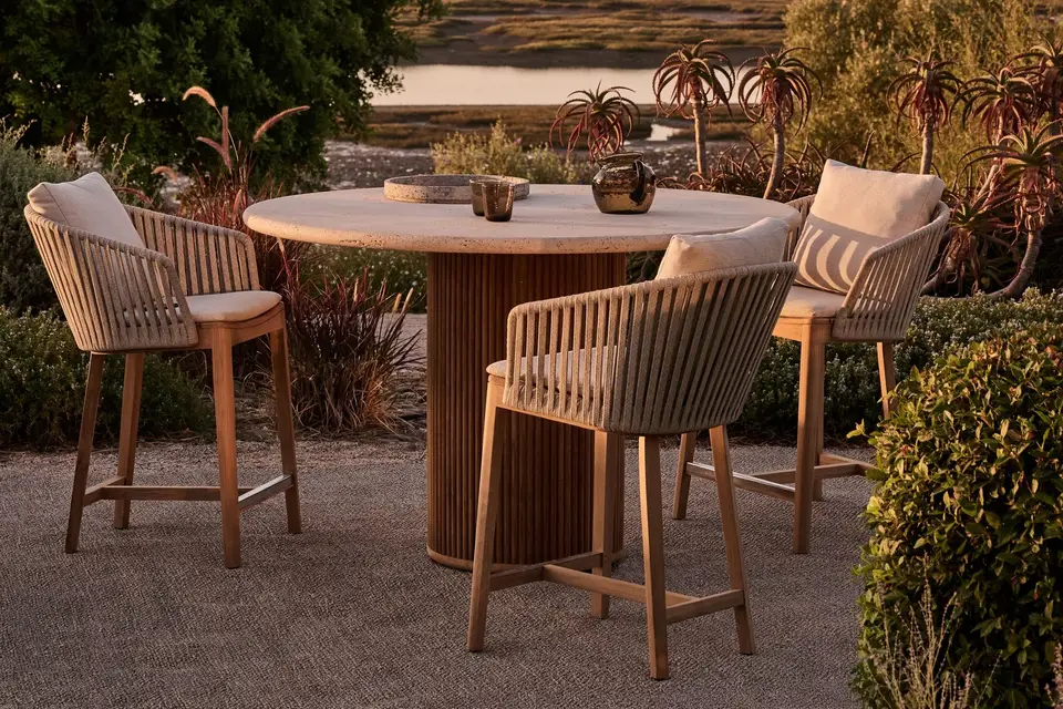 Tribù Mood counter-height chairs in teak and woven Tricord around a round table in a garden